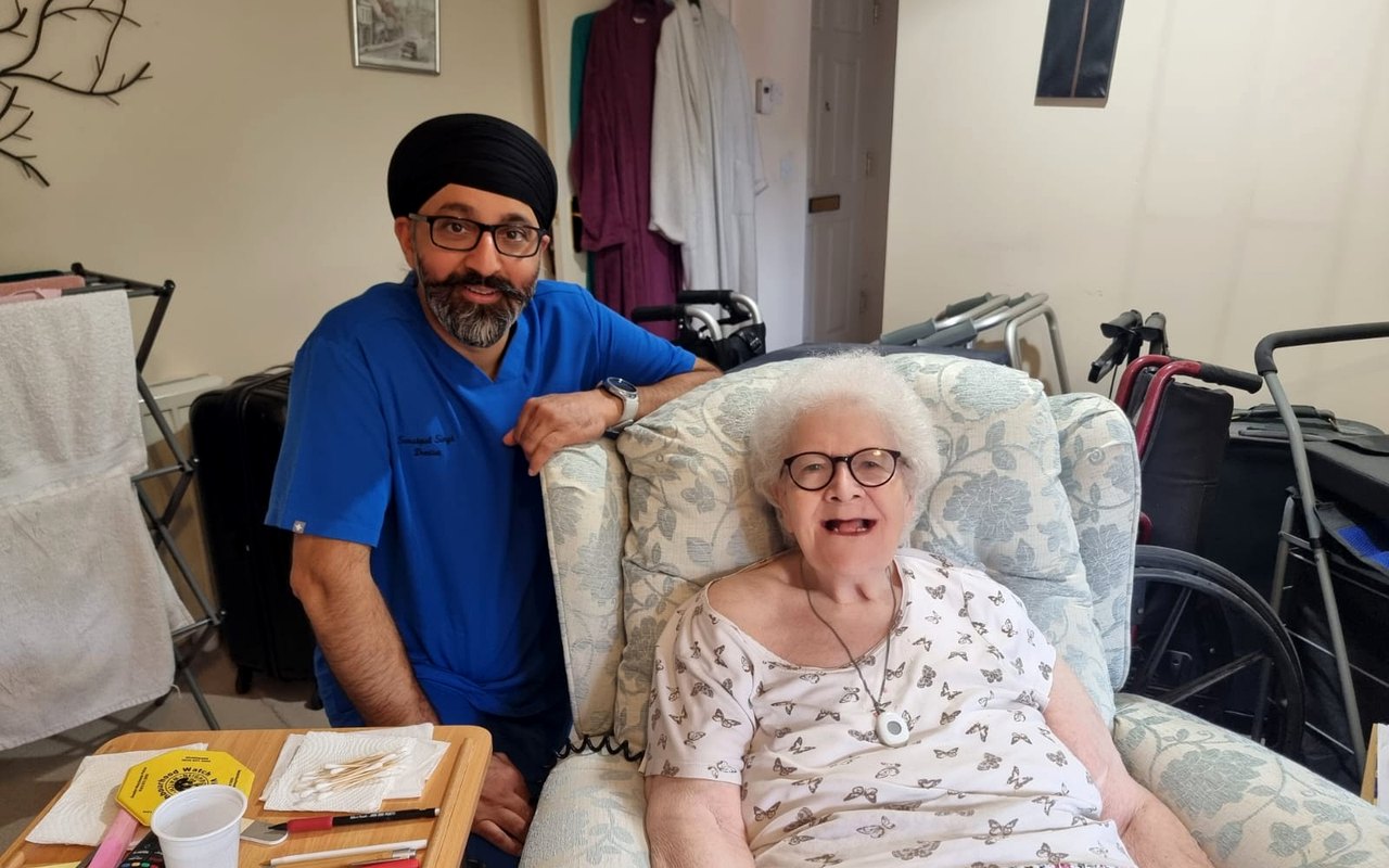 Home visit dentist caring for a patient at home in London